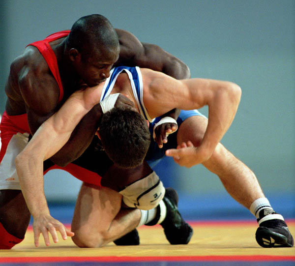 Daniel Igali pictured on the way to a gold medal at the Sydney 2000 Olympic Games is part of the final presentation team