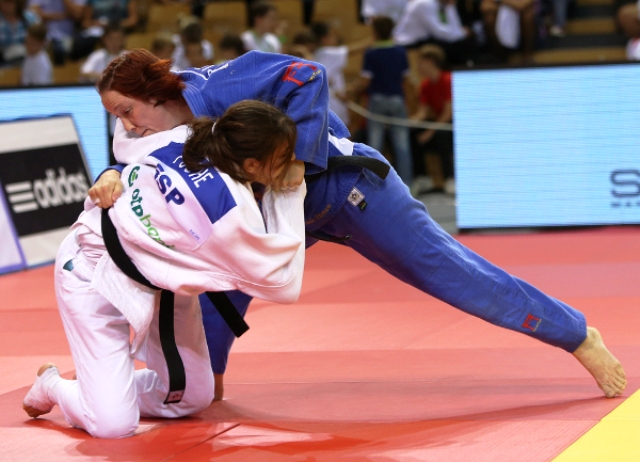 Great Britain's Faith Pitman (blue) claimed her first ever Grand Prix title with victory in the -63kg category