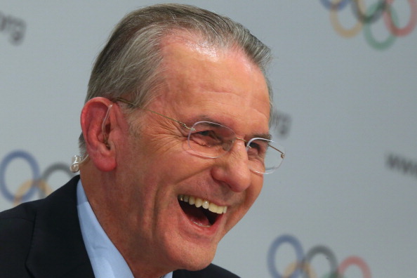 Jacques Rogge cracked a rare smile to the delight of a large posse of photographers