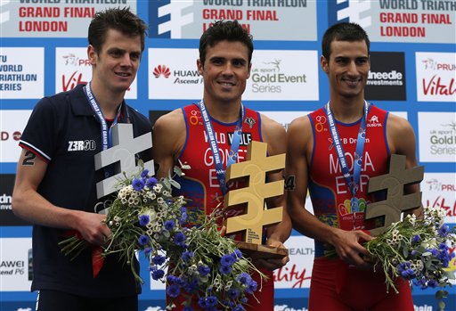 Javier Gomez flanked by Jonny Brownlee and Mario Mola on the world championship podium in London