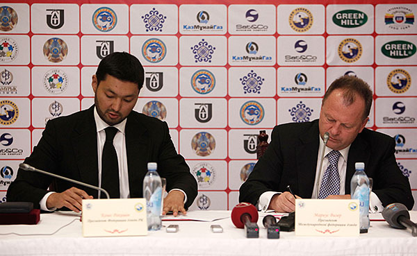 International Judo Federation President Marius Vizer (rights) signs a deal for the 2015 World Championships to be held in Astana