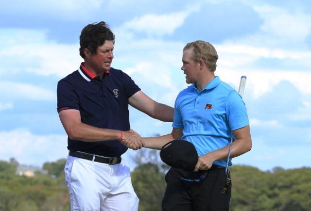 Nathan Smith (left) shakes hands with England's Nathan Kimsey after his putt won the Walker Cup back for the USA