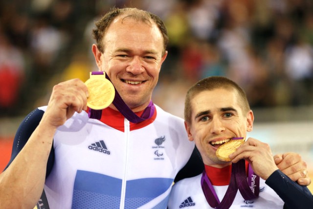 Neil Fachie (right) and partner Barney Storey celebrate their gold medal triumph at London 2012