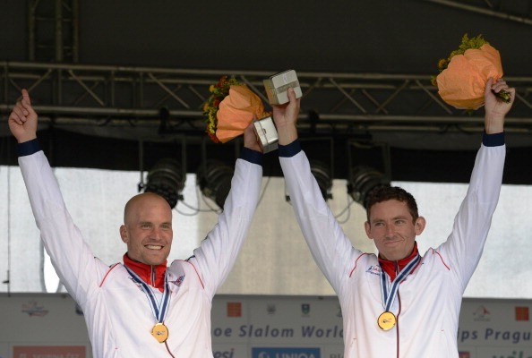 Richard Hounslow and David Florence right raise their arms in celebration after receiving their World Championship gold medals in Prague