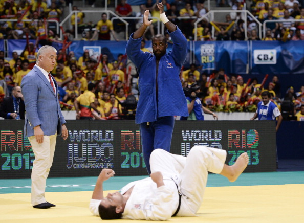 Teddy Riner (blue) of France celebrates his victory against Rafael Silva of Brazil in the over 100kg final category at the World Championships