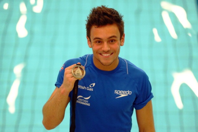 Tom Daley celebrates with his gold medal from the FINA World Diving Series held in Edinburgh earlier this year