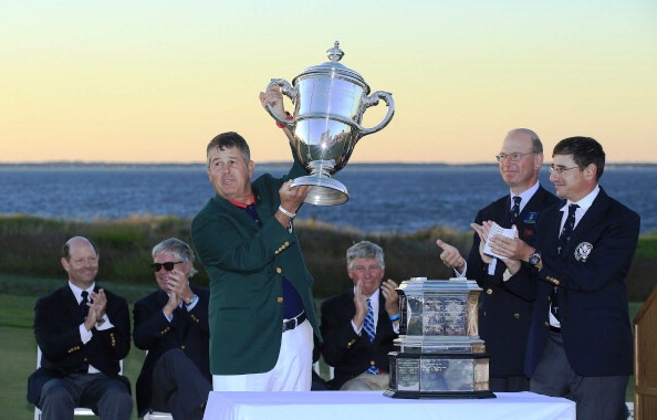 US Walker Cup captain Jim Holtgrieve proudly lifts the trophy following his team's comprehensive win in New York