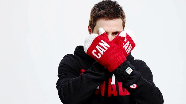 Vancouver 2010 gold medallist Alexandre Bilodeau shows off his Sochi 2014 red mittens