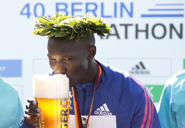 Kenya's Wilson Kipsang sips a German beer after breaking the marathon world record in Berlin