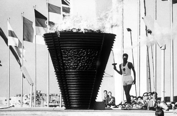 Yoshinori Sakai, born on the day of the Hiroshima bomb, lights the Tokyo 1964 Olympic flame