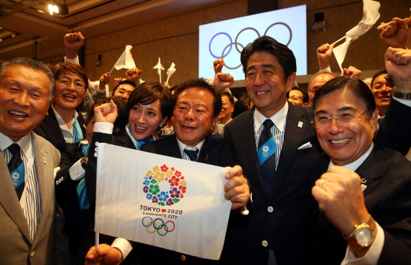 Tokyo 2020 chief executive Masato Mizuno, Japanese Prime Minister Shinzo Abe, Tokyo Governor Naoki Inose and ambassador Christel Takigawa celebrate as they are awarded the Olympics and Paralympics