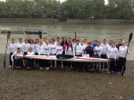 Crewroom founder Kate Giles poses with the British canoe and Para canoe squads on the rainy banks of the Thames