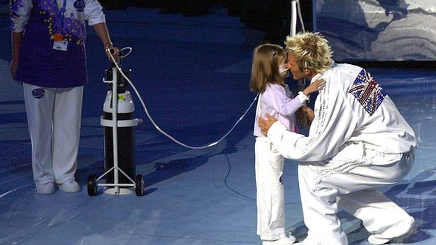 David Beckham hands the Queen's Baton to six-year-old Kirsty Howard at the Opening Ceremony of the 2002 Commonwealth Games in Manchester