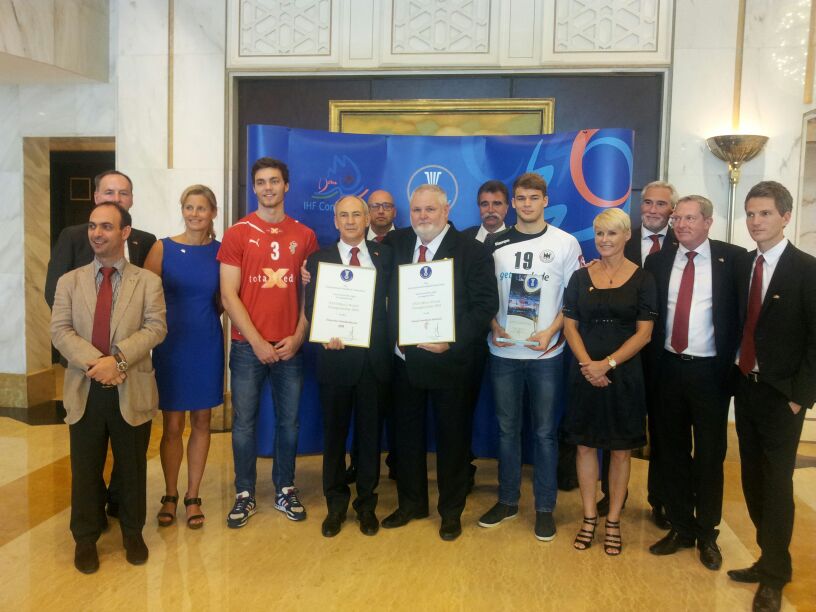 Denmark and Germany handball officials celebrate after their joint bid was chosen to host the 2019 men's World Championships