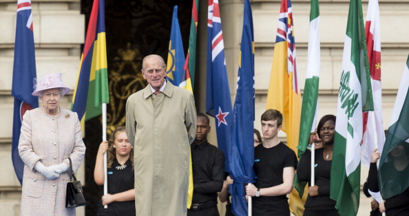 Elizabeth II and the Duke of Edinburgh in front of a parade of flags from all 70 Commonwealth Games participants