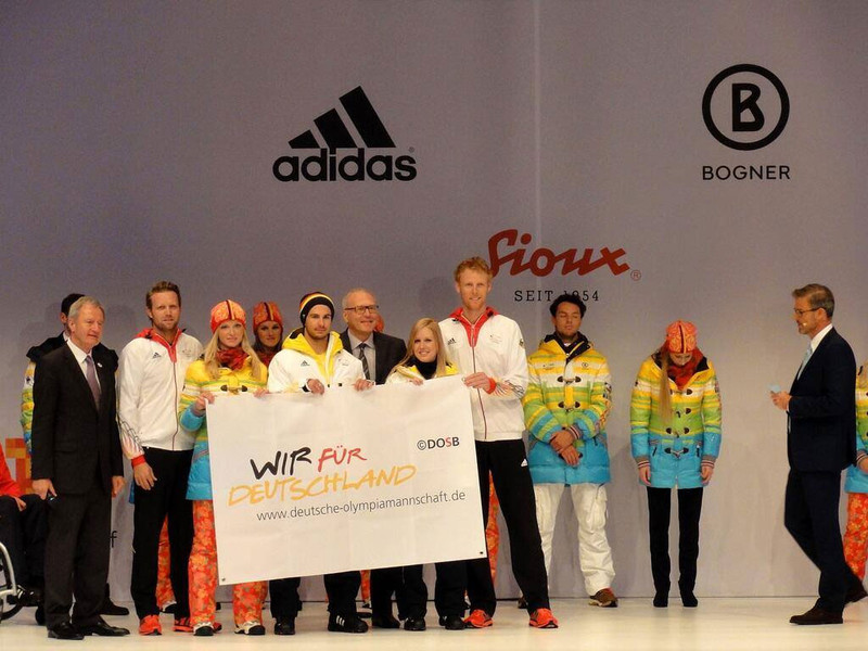 Olympic beach volleyball champions Julius Brink (second from left) and Jonas Reckermann (fourth from right) handed over the flag that had flown at the Athletes' Village in London 2012 as a good luck charm to the Sochi 2014 athletes