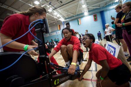 One budding rower strains to fit in that extra stroke as her schoolmate shouts encouragement