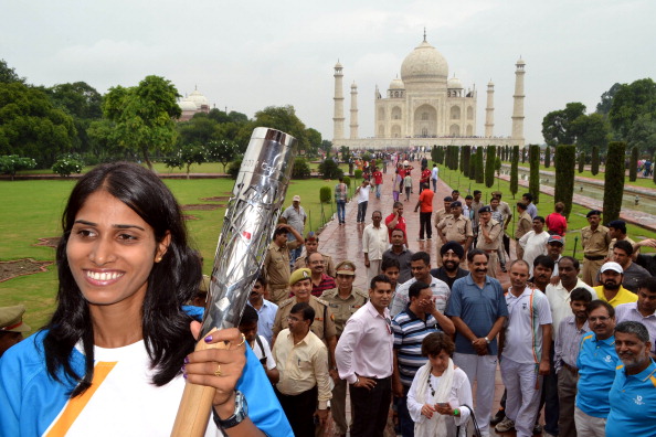 Asian Games 3,000 metres steeplechase champion Sudha Singh holds the Queen's Baton at the Taj Mahal in Agra