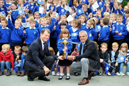 Ryder Cup captains Tom Watson of the USA (left) and Paul McGinley of Europe show off the famous trophy to pupils at Auchterarder Community School in Perthshire