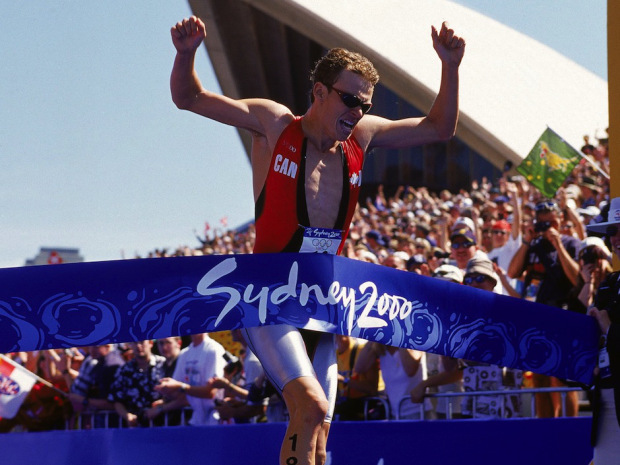 Simon Whitfield crossing the line to win the first ever mens triathlon gold medal in London