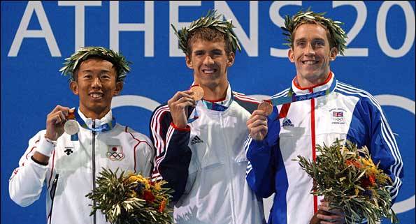 Steve Parry alongside his lookalike Michael Phelps on the medal podium in Athens