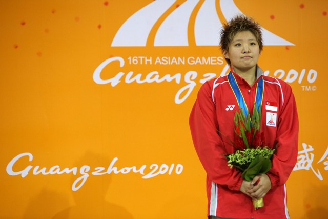 Singapore swimmer Tao Li celebrates winning the gold medal in the 50 metres butterfly at the 2010 Asian Games in Guangzhou