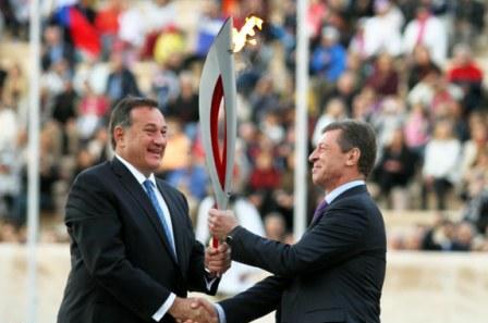 The Flame is passed from HOC President Spyros Caprolos to Russias Deputy Prime Minister Dmitry Kozak