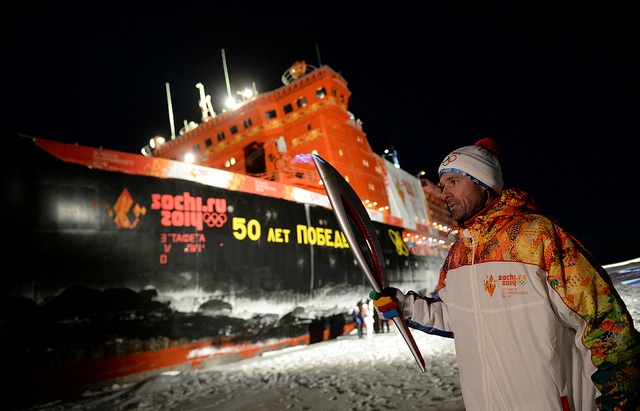 The Torch is carried close to the icebreaker which made the journey to the North Pole