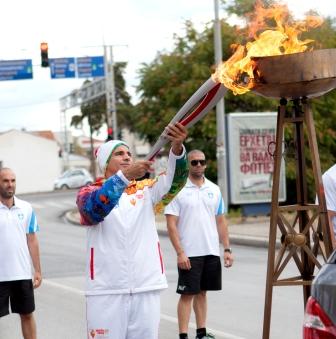 Torchbearer Matthew Hotos carried the Flame on Tuesday midway through its six day journey around Greece
