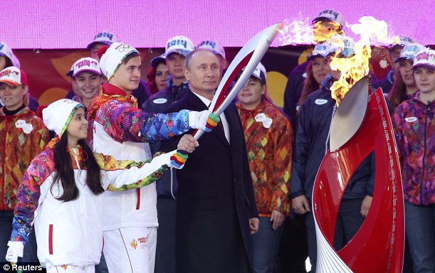 Torchbearers accompany Russian President Vladmir Putin at the beginning of a four month journey throughout Russia