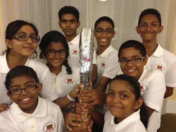 Young members from the Swimming Association of the Maldives held the baton when it briefly arrived at the airport last night