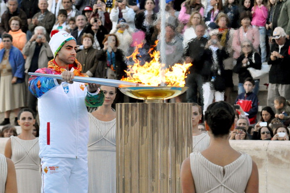 Greek figure skating champion Panagiotis Markouizos lights the cauldron during the Sochi 2014 Olympic Torch Handover Ceremony