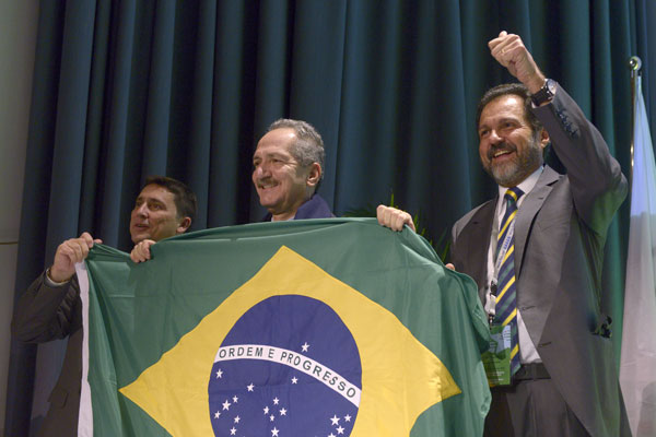 Luciano Cabral, President of the Brazilian University Sports Confederation, Aldo Rebelo, Brazil's Sports Minister, and Angelo Queiroz, Governor of the Federal District of Brasilia, celebrate the capital being awarded the 2019 Summer Universiade