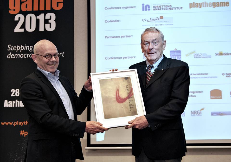 Dick Pound receiving the Play the Game 2013 Award from Søren Riiskjær, vice-chairman of the board of Play the Game/Danish Institute for Sports Studies 
