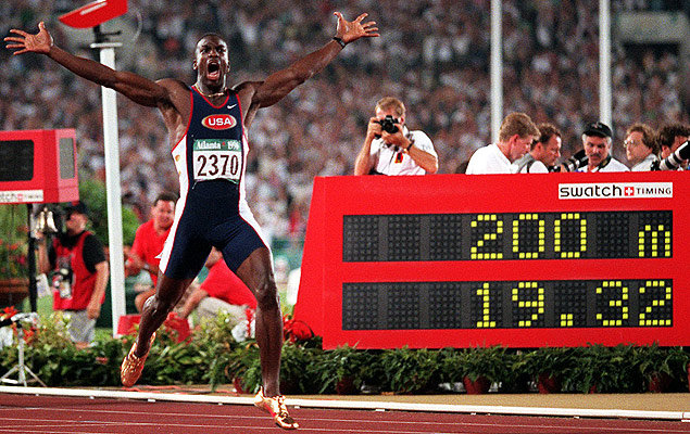 American Michael Johnson celebrates breaking the world record in the 200 metres in the Centennial Olympic Stadium at Atlanta, adding it to the gold medal he had won in the 400m