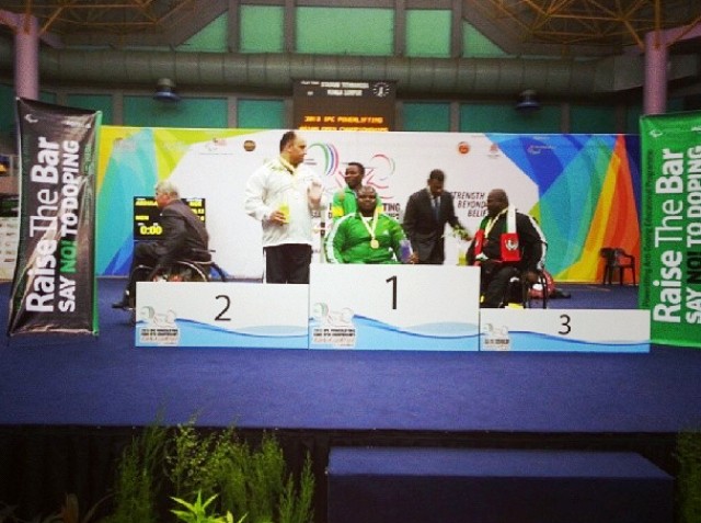 Nigerian Abdulazeez Ibrahim (centre) receives his gold medal in the under 97kg category