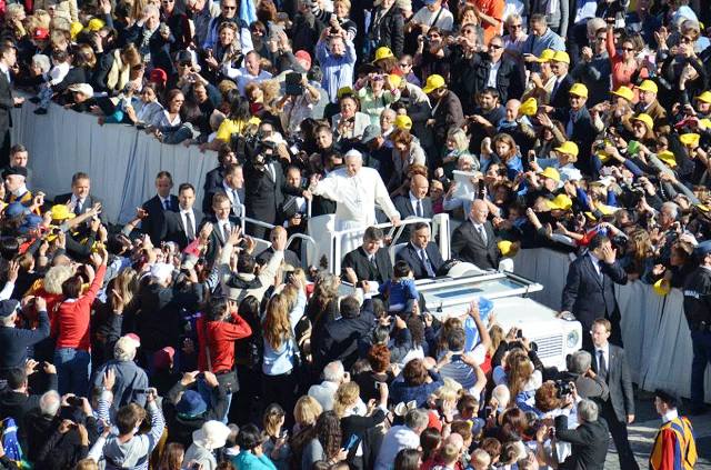 Pope Francis is greeted by large crowds in St Peters Square before officially lighting the Trentino 2013 torch