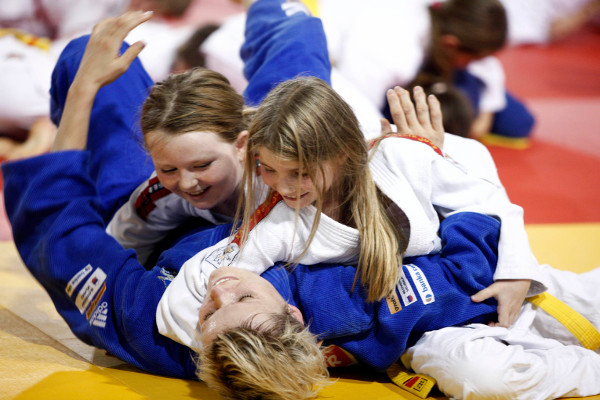 Youngsters team up to hold down Slovenia's Olympic champion Urska Zolnir at an event in Ljubljana attended by IJF President Marius Vizer to celebrate World Judo Day
