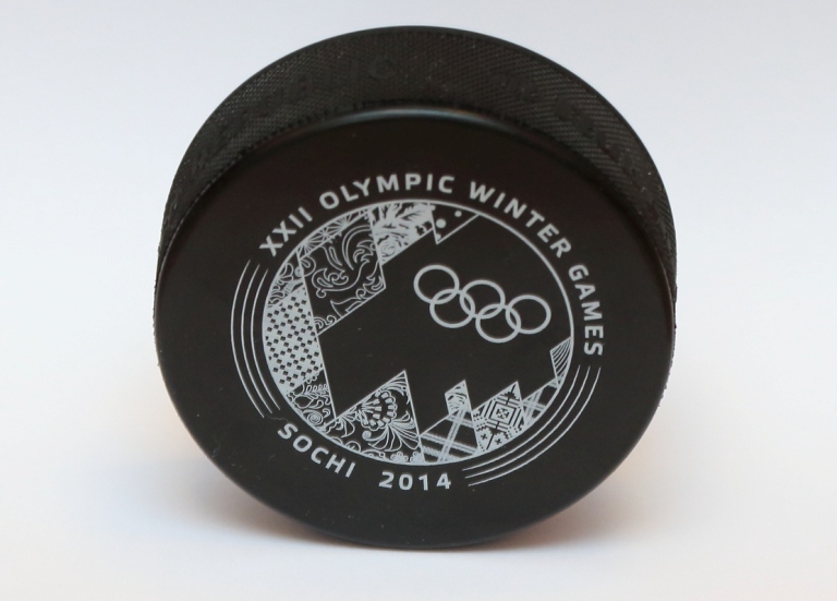 One side of the official Sochi 2014 ice hockey pucks features a coloured design, while the reverse is black and white ©Sochi 2014