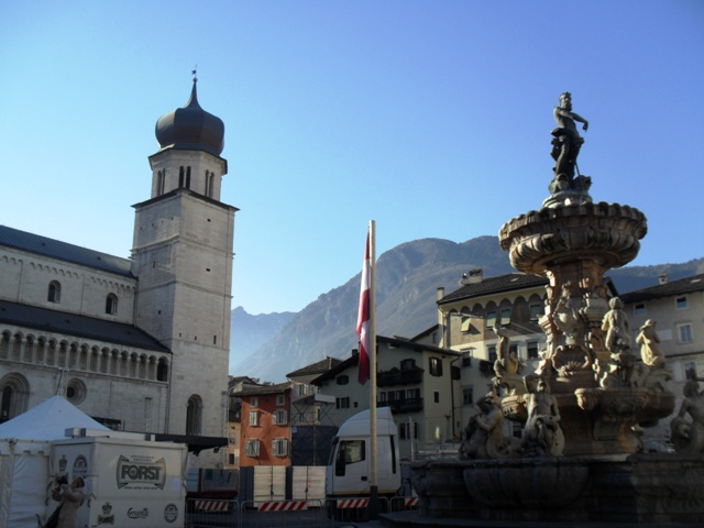 The spire of the Santa Croce Church in the Piazza Duomo is dwarfed by the imposing Dolomite mountains that surround Trento ©Gary Anderson/ITG