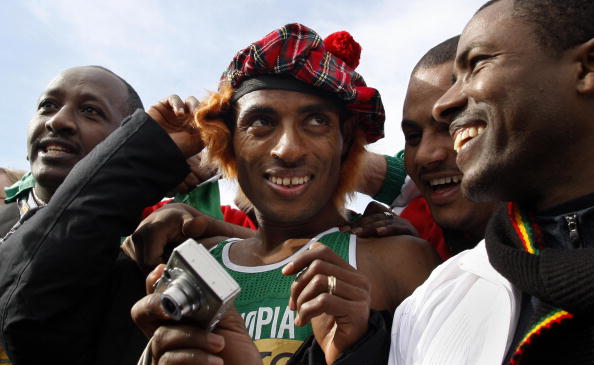 Kenenisa Bekele gets a Scottish wig and bonnet in Edinburgh in 2008 to mark his sixth long course win at the World Cross Country Championships. Now, with sights set on a 2014 marathon debut, he plans to return to Edinburgh in January for another cross country ©AFP/Getty Images
