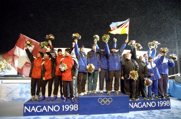 France's four-man bob team, coached by Ivo Ferriani, share the bronze medal podium position with Britain at the Nagano 1998 Games, alongside gold medallists Germany and silver medallists Switzerland ©Getty Images
