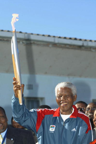 Nelson Mandela carries the Athens 2004 Olympic Torch in Cape Town, the South African city that the Greek capital beat to be awarded the Games ©Getty Images