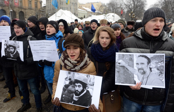 Ukrainian protesters in Lviv carry pictures of the two killed in clashes with riot police on Wednesday ©Getty Images 