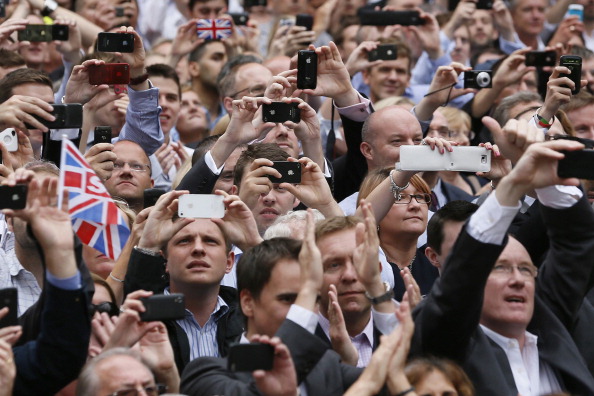 Spectators in London used their mobile phones to record and photographs British athletes as they celebrated their London 2012 Olympic and Paralympic success