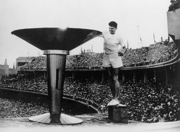 A young Ron Clarke lights the Olympic Cauldron at his home Games of 1956 in Melbourne - but he would never win an Olympic title despite his superb abilities ©Getty Images