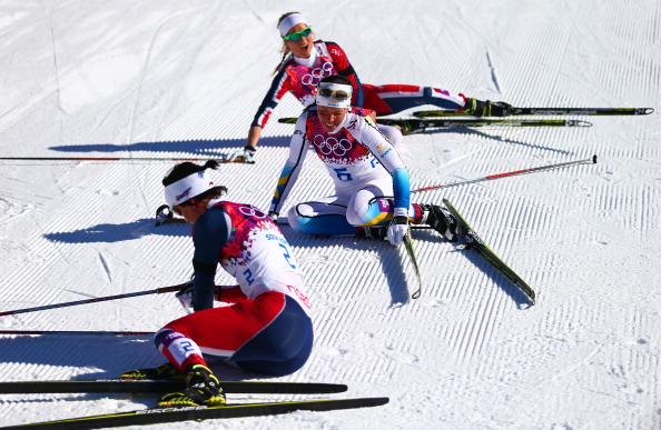 Exhausted scenes at the end of the women's cross country as the three medal winners collapse on the snow ©Getty Images