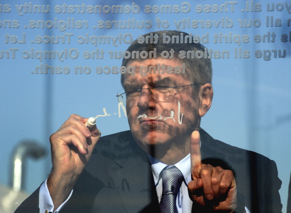 IOC President Thomas Bach writing on the Olympic Truce Wall after its unveiling this morning ©Getty Images