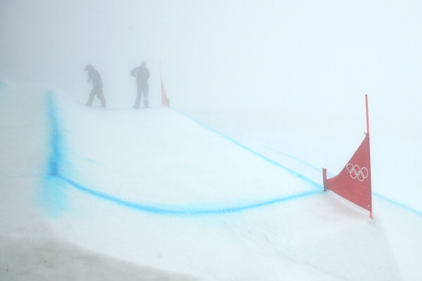 Sochi 2014 officials can be barely seen through the fog at  Rosa Khutor Extreme Park forcing organisers to postpone events ©Getty Images