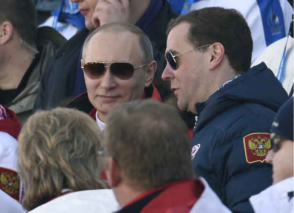 Russian President Vladimir Putin and prime minister Dmitry Medvedev watch the host nation win cross country relay silver earlier on today ©AFP/Getty Images